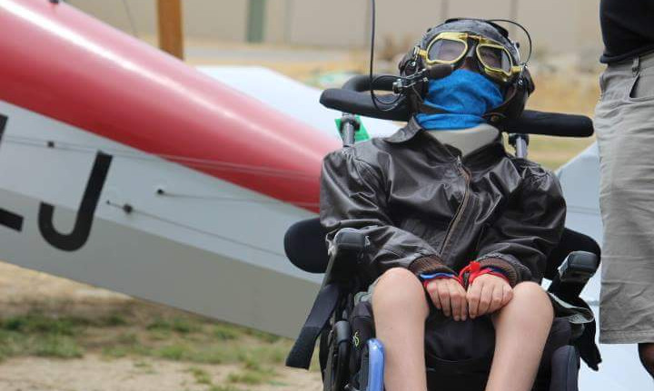 man on wheelchair going down dirt track